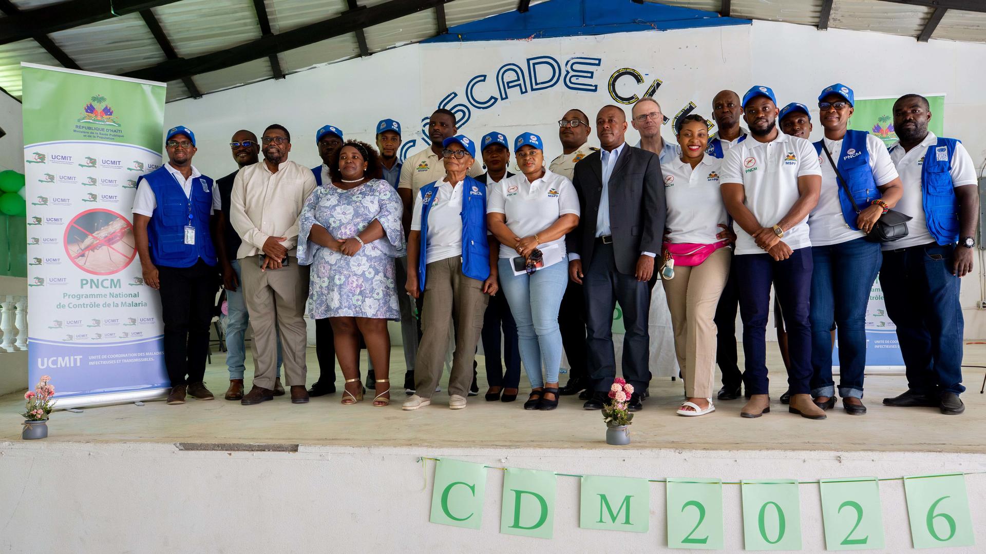 Group of people on a stage at a conference, banners on sides, CDM 2026 sign.