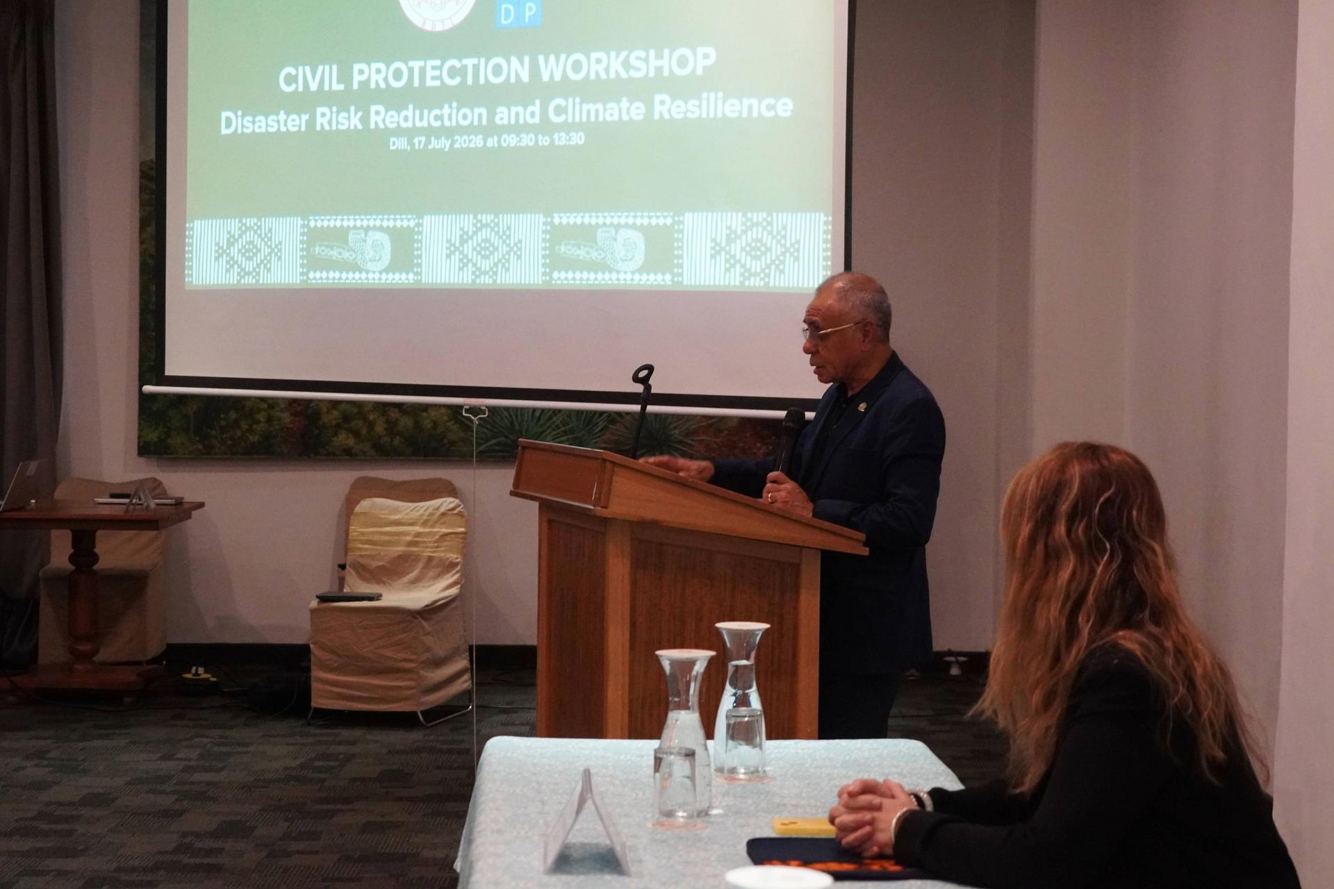 H.E. Minister of Interior Francisco da Costa Guterres during Civil Protection Workshop; projection screen visible.