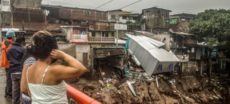 Women overlooking the damage caused by storm Amanda