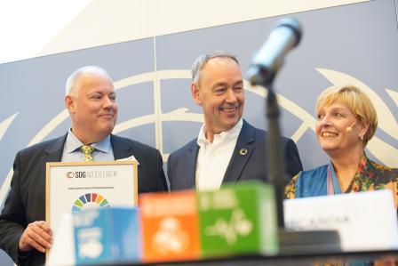 People smiling getting an award