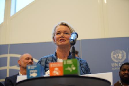 Woman speaking in front of audience