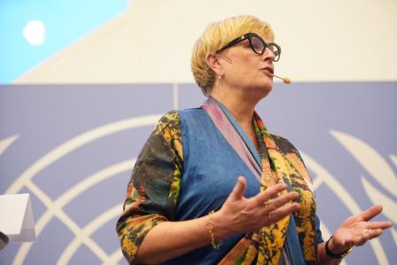 Woman speaking in front of audience