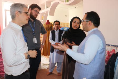 Zahra, a female entrepreneur in Herat meets with UNDP's Francisco Santos-Jara Padron and George May from the Bangkok Regional Human Mobility Team. UNDP and UNHCR support her plans to expand her business.
