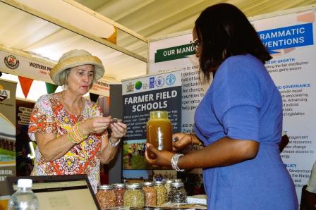A guest samples Sioma Honey, produced by farmers opting for alternative livelihood in Sioma District, a SCRALA project site