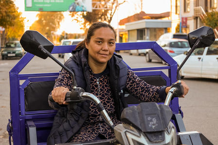 A woman driving an electric scooter. 