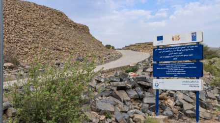 a sign on a rocky hill