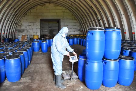 a person standing in front of a barrel