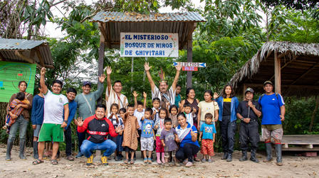 a group of people standing in front of a crowd posing for the camera