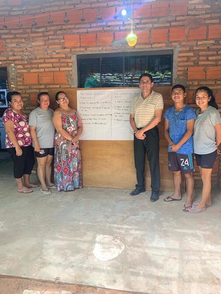 a group of people standing in front of a brick wall