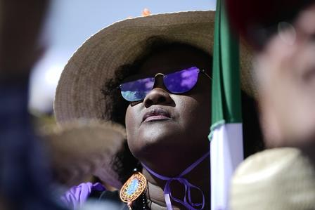 a close up of a person wearing a hat and sunglasses