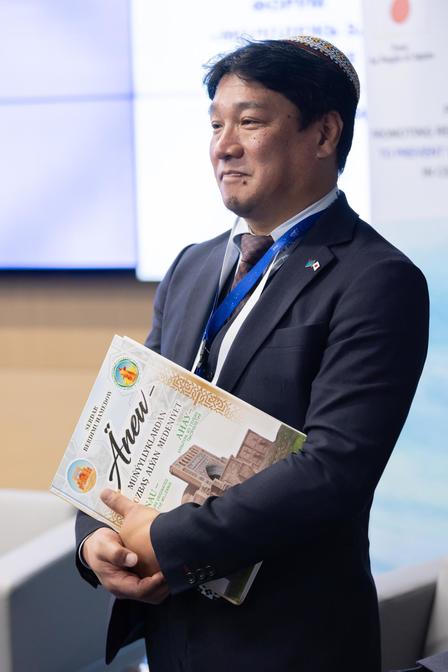 a man wearing a suit and tie reading a book
