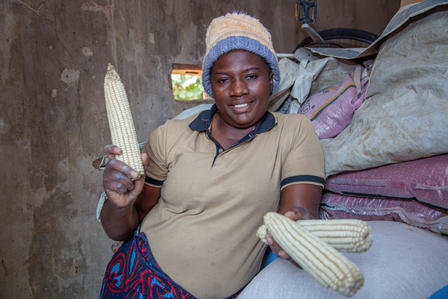 Brilliant Chivunga holding the maizwe she harvested.