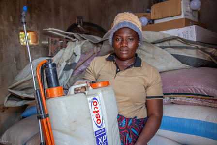 Woman holding a sprayer for farming.