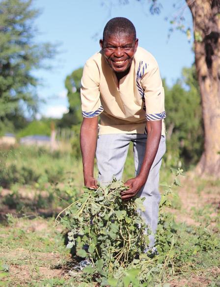a man standing next to a tree