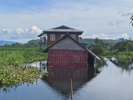 A once peaceful home in Nyaung Shwe Township now stands partially submerged as floodwaters take over the landscape.