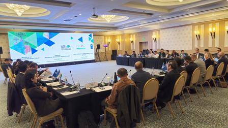 a group of people sitting at a desk in an office