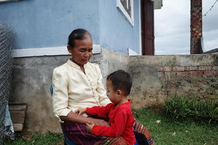 a little boy sitting in front of a building