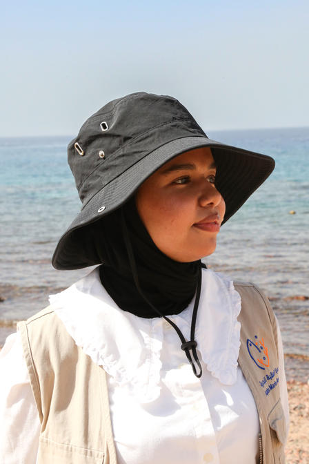 a person standing next to a body of water