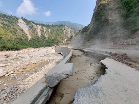 a road destroyed by floods and landslides