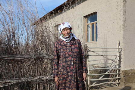 a person standing next to a fence