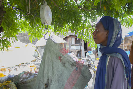 a person talking weighing waste