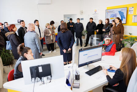 a group of people standing in front of a computer