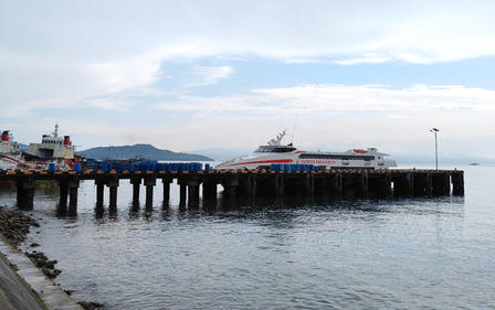 a group of people on a pier next to a body of water