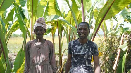a person standing next to a palm tree