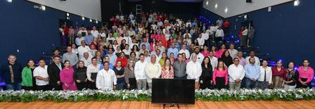 a group of people standing in front of a crowd posing for the camera