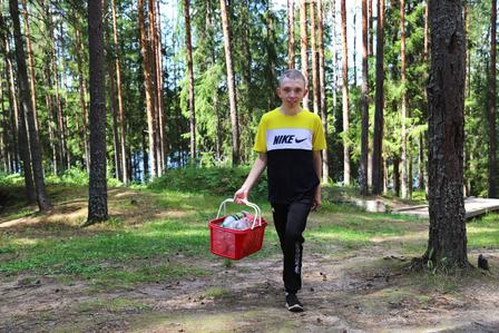 a man throwing a frisbee in a wooded area