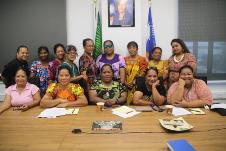 a group of people sitting at a table posing for the camera