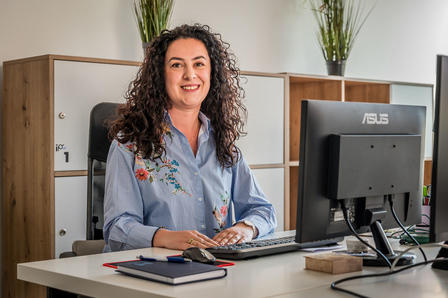a person sitting at a desk in front of a computer