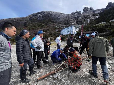 a group of people standing on top of a mountain