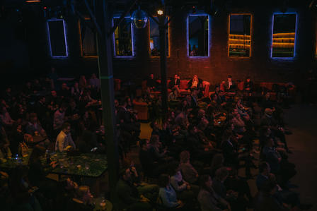 a crowd of people in a dark room