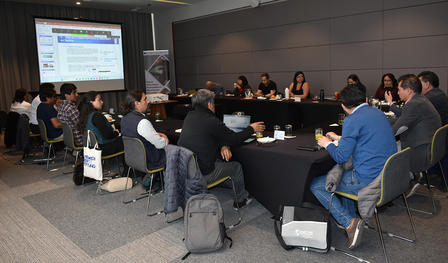a group of people sitting at desks in a room