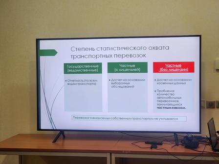 A TV screen displaying a presentation about transport statistics with three sections highlighted.
