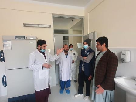 a group of people standing in a kitchen