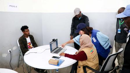 a group of people sitting at a desk