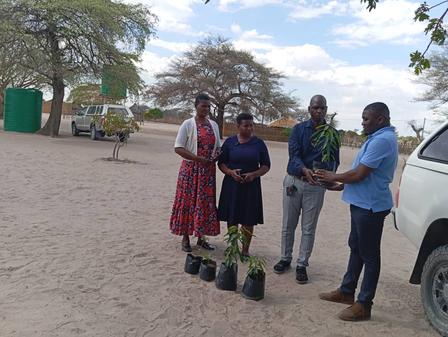 a group of people standing with plants