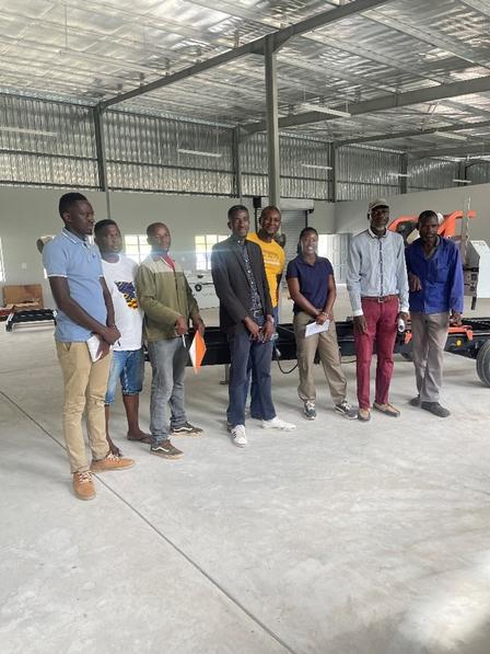 a group of artisans standing in a warehouse