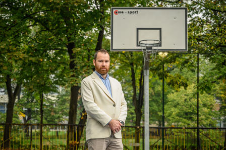 a man holding a sign posing for the camera