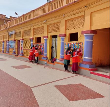 a group of people painting on the walls of a building