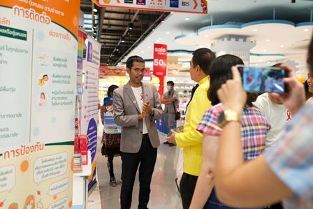 A group of professionals engages in conversation in a brightly lit store.