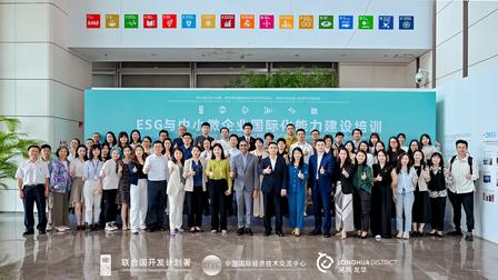 A large group of diverse individuals posing together in a bright indoor space.