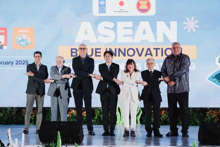 Group of seven individuals standing on stage with arms crossed, promoting ASEAN Blue Innovation.