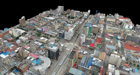 Aerial view of a cityscape featuring various buildings and colorful rooftops.