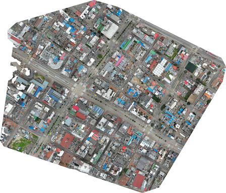 Aerial view of a densely packed urban area with various buildings and roads.