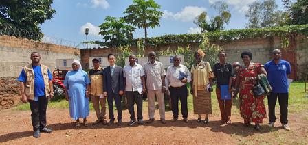 Group of diverse people standing together outdoors in a sunny setting.