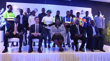 A diverse group of professionals and officials posing together on a stage.