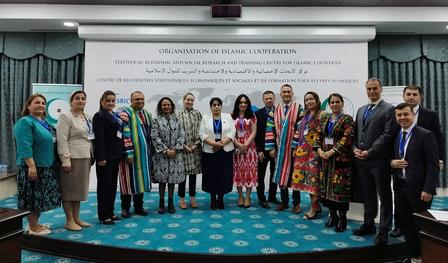 A group of diverse professionals pose together in formal attire, smiling in a conference setting.